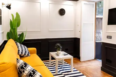 a living room with a yellow couch and a table at Key Apartment Obelisco in Rome