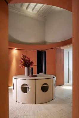 a lobby with a round table with flowers on it at Hotel Trame in Rome