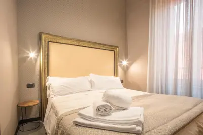 a bedroom with a bed with towels on it at Rometobe in Rome