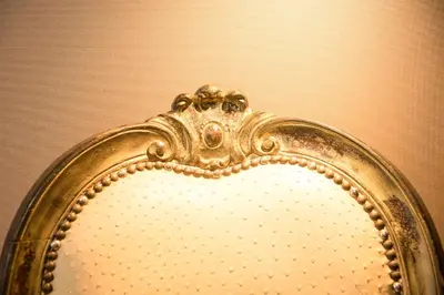 a gold mirror with a tiara on it at Rometobe in Rome