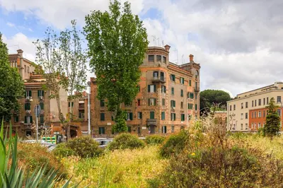 an old brick building with a tree in front of it at La terrazza al Cupolone in Rome