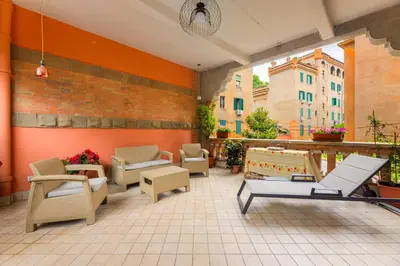 a patio with chairs and furniture on a building at La terrazza al Cupolone in Rome