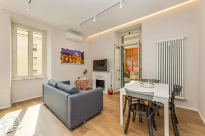 a living room with a table and a chair and a couch at La terrazza al Cupolone in Rome