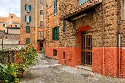 a brick building with an open door on a street at La terrazza al Cupolone in Rome
