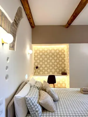 a bedroom with a bed with white pillows and a window at Salotto34 in Rome