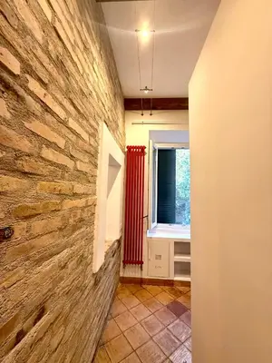 a hallway with a stone wall and a window at Salotto34 in Rome