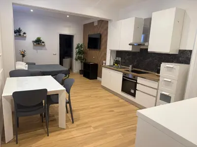 a kitchen and living room with a table and chairs at NAVONA MORGAN suite in Rome