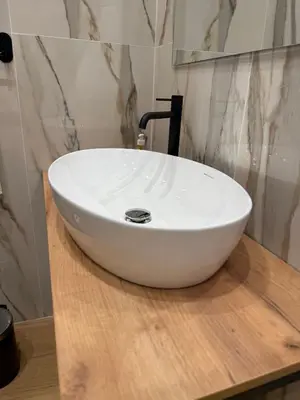 a white sink on a wooden counter in a bathroom at NAVONA MORGAN suite in Rome