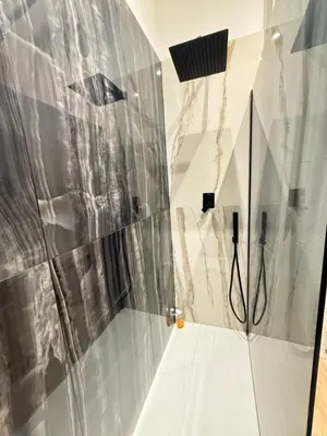 a shower in a bathroom with a glass wall at NAVONA MORGAN suite in Rome
