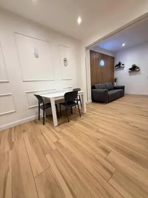 a living room with a table and chairs and a couch at NAVONA MORGAN suite in Rome
