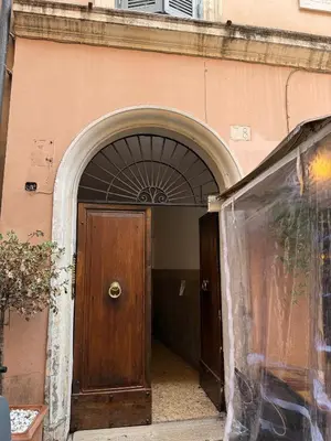 an entrance to a building with a wooden door at NAVONA MORGAN suite in Rome
