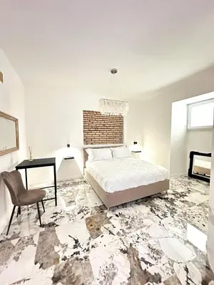 a bedroom with a bed and a table and a chair at Callas Luxury Apartment in Rome