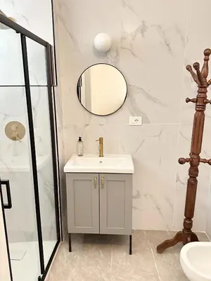 a bathroom with a sink and a mirror at Callas Luxury Apartment in Rome