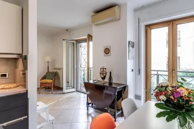 a kitchen and living room with a table and chairs at Lovely flat near Vaticano in Rome
