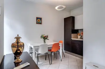 a kitchen and dining room with a table and chairs at Lovely flat near Vaticano in Rome