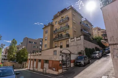 a tall building with cars parked in front of it at Lovely flat near Vaticano in Rome