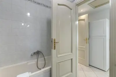 a bathroom with a tub and a shower and a door at Lovely flat near Vaticano in Rome
