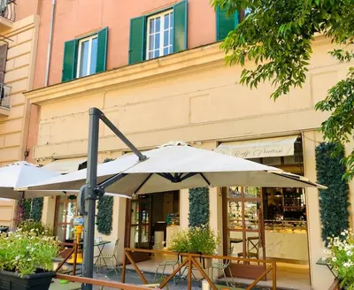 a table with an umbrella in front of a store at Residenza Prati in Rome