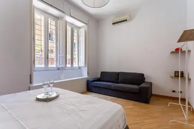 a living room with a bed and a couch at Residenza Prati in Rome