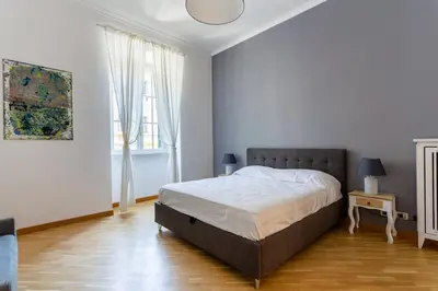 a white bedroom with a bed and a window at Residenza Prati in Rome