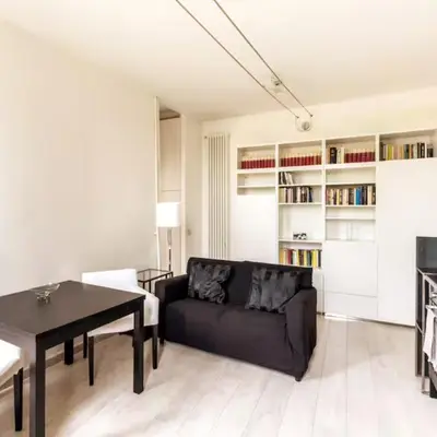 a living room with a black couch and a table at Monastery's View Home in Rome