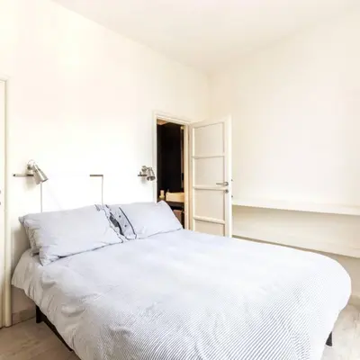 a white bedroom with a large white bed at Monastery's View Home in Rome