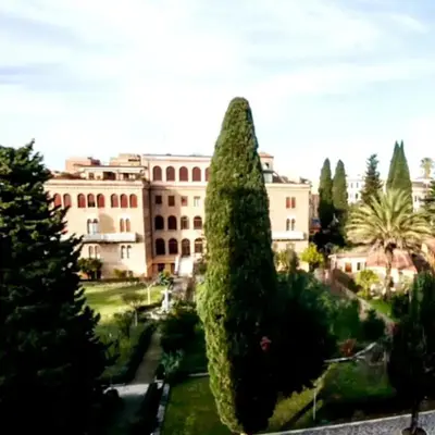 a view of a building and a large tree at Monastery's View Home in Rome