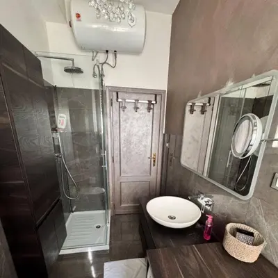 a bathroom with a sink and a shower at Colle Aurelio Home in Rome