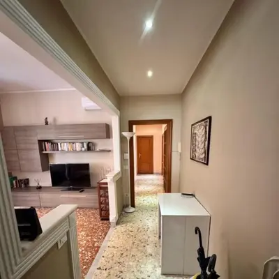 a living room with a white table in a room at Colle Aurelio Home in Rome