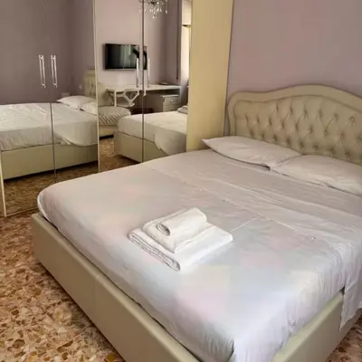 a bedroom with a bed with a white towel on it at Colle Aurelio Home in Rome