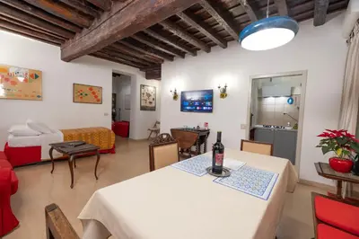 a living room with a table and a bedroom at Casa Mirella near Piazza Navona, Rooftop Views in Rome
