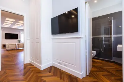 a bathroom with a flat screen tv on a wall at Amazing Vittoriano in Rome