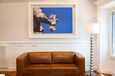 a couch in a living room with a picture on the wall at Amazing Vittoriano in Rome