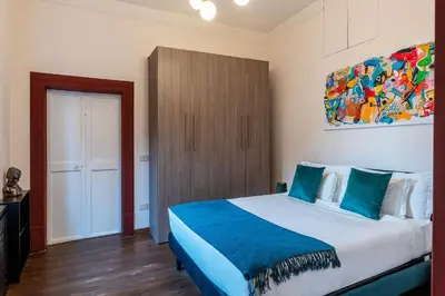 a bedroom with a bed and a painting on the wall at Casa Mia Trastevere in Rome