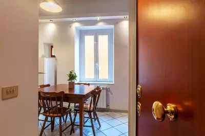 a dining room with a table and chairs and a window at Casa Mia Trastevere in Rome