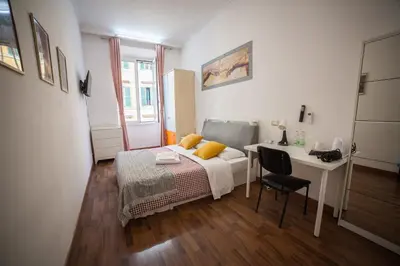 a bedroom with a bed and a desk and a table at Cosmo Terzo GuestHouse Roma in Rome