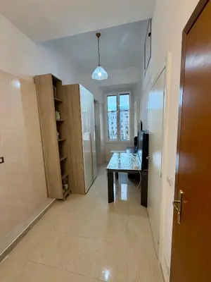 an empty room with a table and a television at Cosmo Terzo GuestHouse Roma in Rome