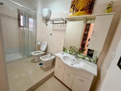 a bathroom with a sink and a toilet and a mirror at Cosmo Terzo GuestHouse Roma in Rome