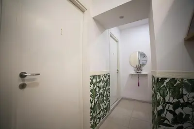 a hallway with a door and a mirror at Cosmo Terzo GuestHouse Roma in Rome