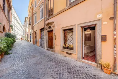 a cobblestone street in an alley with buildings at Colosseum Loft, Rustic-modern charm in Rome