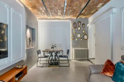 a living room with a couch and a table at Colosseum 1 Min Design Apt with Private Courtyard in Rome