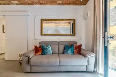 a living room with a couch with pillows on it at Colosseum 1 Min Design Apt with Private Courtyard in Rome