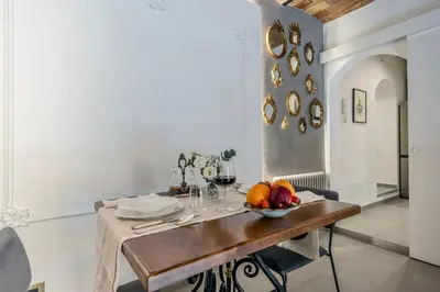 a dining room table with a bowl of fruit on it at Colosseum 1 Min Design Apt with Private Courtyard in Rome