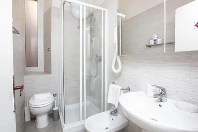 a bathroom with a shower and a toilet and a sink at Zen 31 - Colosseum cozy apartment in Rome
