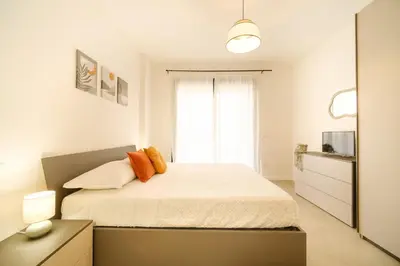 a white bedroom with a bed and a window at Bonelli 67 Apartment in Rome