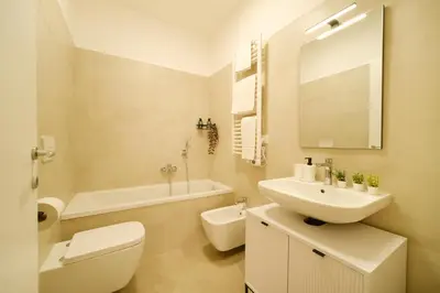 a bathroom with a sink and a toilet and a tub at Bonelli 67 Apartment in Rome