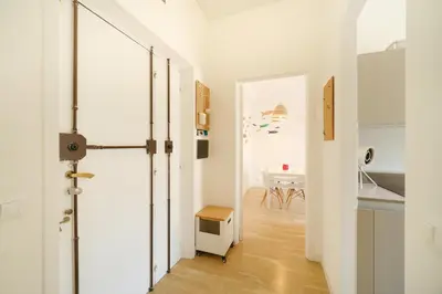 a hallway with a door to a kitchen with a table at Blue Apartment Testaccio & Trastevere in Rome