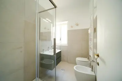 a bathroom with a shower and a toilet and a sink at Blue Apartment Testaccio & Trastevere in Rome