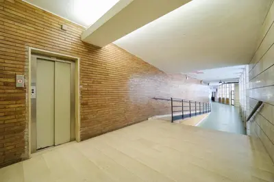 an empty hallway with a door and a brick wall at Blue Apartment Testaccio & Trastevere in Rome
