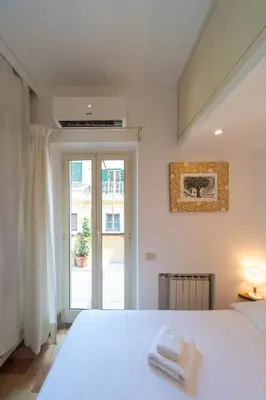 a bedroom with a white bed with towels on it at My Monti Charming Holiday Home in Rome